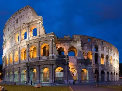 a large building with its lights on at night at La Piccola Maison in Rome