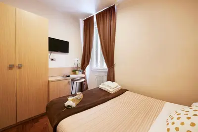 a hotel room with a bed and a sink at La Piccola Maison in Rome