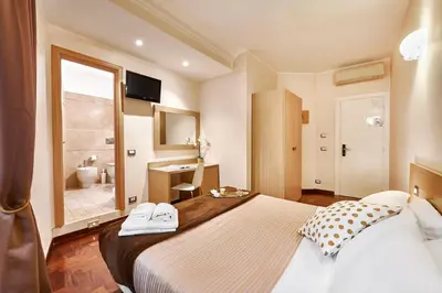 a bedroom with a large bed and a bathroom at La Piccola Maison in Rome