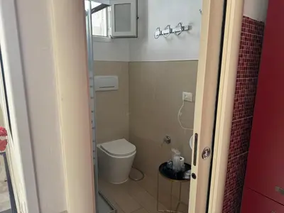 a small bathroom with a toilet and a sink at Vacanze Romane in Rome