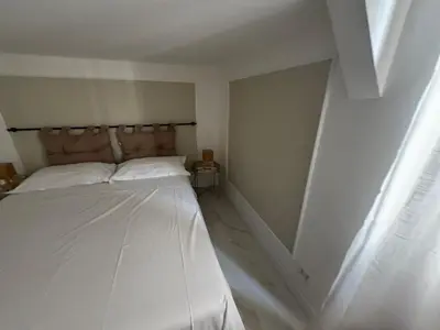 a white bedroom with a bed in a room at Vacanze Romane in Rome