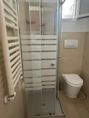a bathroom with a glass shower and a toilet at Vacanze Romane in Rome