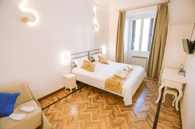 a bedroom with a bed and a couch in a room at Casa Pan in Rome