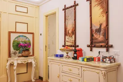 a room with a dresser and a table with a picture at Casa Pan in Rome