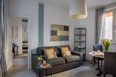 a living room with a couch and a table at Now Apartments, ApartHotel in the heart of Rome in Rome