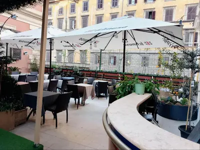 a hotel room with two beds and a television at Hotel Amadeus in Rome