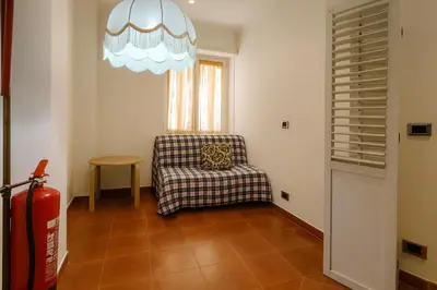 a living room with a chair and a window at La Casa del Viaggiatore in Rome