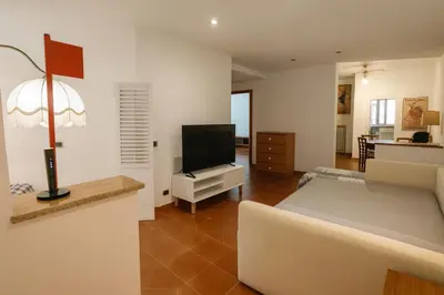 a living room with a couch and a flat screen tv at La Casa del Viaggiatore in Rome
