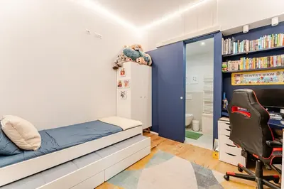 a bedroom with a bed and a desk and a chair at Refined two-bedrooms Roman Residence in Rome
