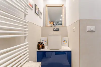 a small bathroom with a mirror and a sink at Refined two-bedrooms Roman Residence in Rome