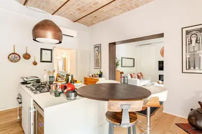 a kitchen with a table in the middle of a room at Refined two-bedrooms Roman Residence in Rome