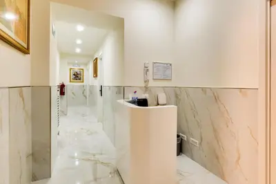 a bathroom with marble walls and a reception counter at Il Rifugio del Re in Rome
