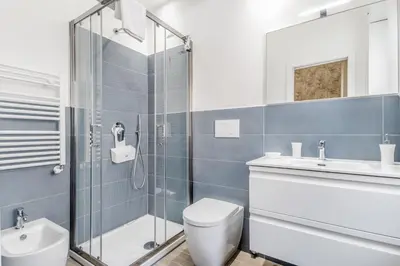 a bathroom with a shower and a toilet and a sink at Elegant and spacious apartment facing the subway near the Vatican in Rome