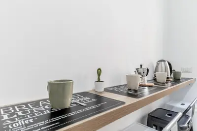 a counter with coffee cups on top of it at Elegant and spacious apartment facing the subway near the Vatican in Rome