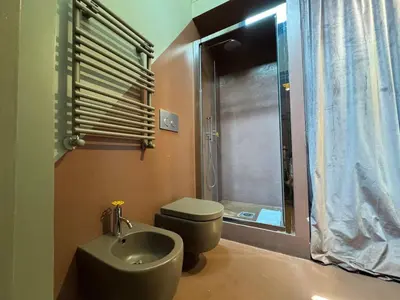 a bathroom with a sink and a toilet and a shower at Monti Penthouse in Rome