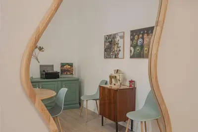 a mirror in a room with a table and chairs at MyRentalInn - Vatican Prestigious Apartment in Rome