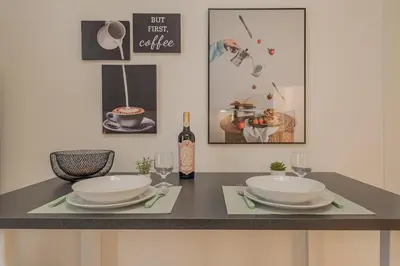 a table with two plates and a bottle of wine at MyRentalInn - Vatican Prestigious Apartment in Rome