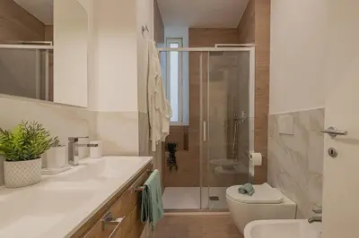 a bathroom with a shower and a toilet and a sink at MyRentalInn - Vatican Prestigious Apartment in Rome