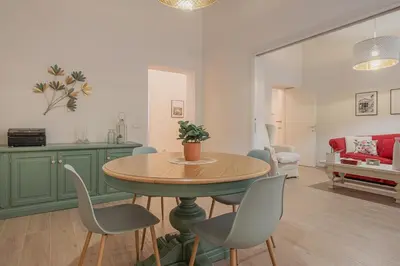 a living room with a table and chairs at MyRentalInn - Vatican Prestigious Apartment in Rome