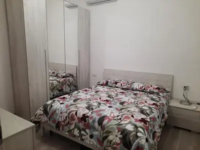 a bedroom with a bed with a floral comforter at Home Delfini in Trastevere in Rome