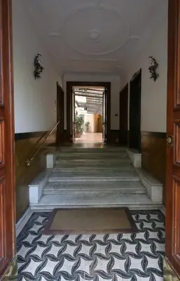 an empty hallway of a building with a door and stairs at Residenza Crescenzio in Rome