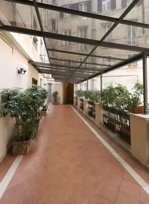 an empty hallway in a building with potted plants at Residenza Crescenzio in Rome