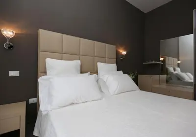 a bedroom with a large bed with white pillows at Residenza Crescenzio in Rome