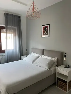 a bedroom with a white bed and a window at Marta Cozy place near Vatican and subway in Rome