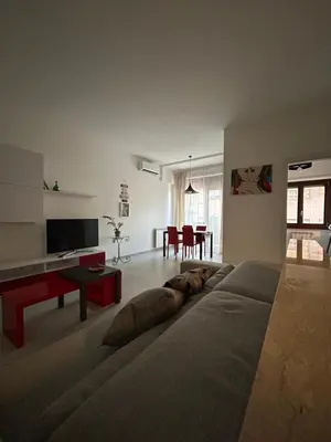 a bedroom with a large white bed and a mirror at Marta Cozy place near Vatican and subway in Rome
