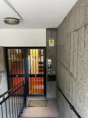 a hallway with a door and a stairway with at Marta Cozy place near Vatican and subway in Rome