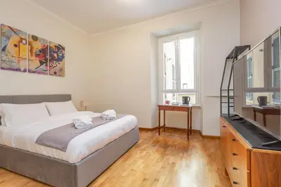 a bedroom with a bed and a flat screen tv at Easybnb - Daisy in Rome