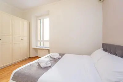 a bedroom with a white bed with towels on it at Easybnb - Daisy in Rome