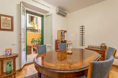 a dining room with a wooden table and chairs at Easybnb - Daisy in Rome