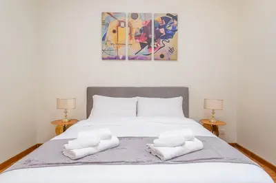 a bedroom with a bed with two towels on it at Easybnb - Daisy in Rome