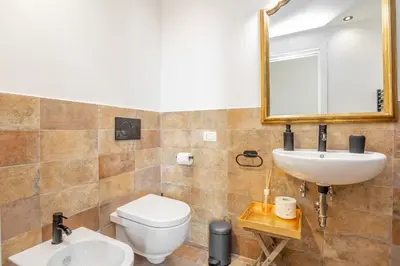 a bathroom with a toilet and a sink and a mirror at Easybnb - Daisy in Rome