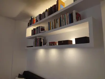 a book shelf with books on the wall at Tanner's Apartment - Piramide in Rome