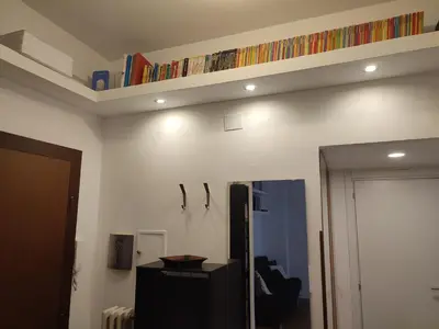 a living room with a shelf on the wall at Tanner's Apartment - Piramide in Rome