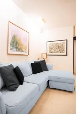 a white couch in a living room with a painting at Pantheon Luxury Apartment in Rome