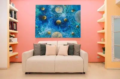a living room with a white couch in front of a painting at Pantheon Luxury Apartment in Rome