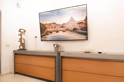 a flat screen tv hanging on a wall at Pantheon Luxury Apartment in Rome
