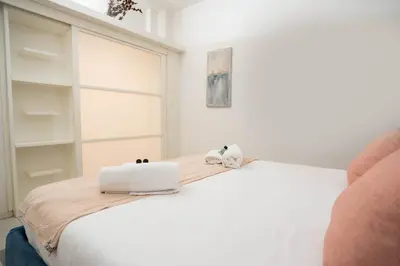 a white bed with two white towels on top of it at Pantheon Luxury Apartment in Rome