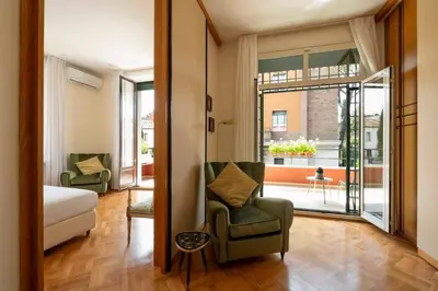 a room with a bed and two chairs and a window at Orange Tree Home in Rome