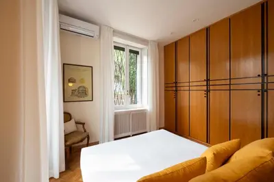 a bedroom with a bed and a couch and a window at Orange Tree Home in Rome