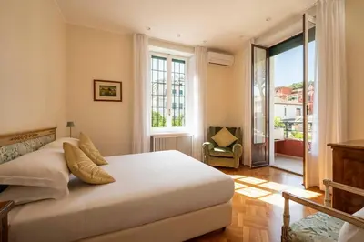 a bedroom with a large bed and a large window at Orange Tree Home in Rome