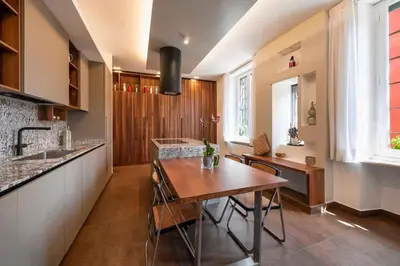 a kitchen with a wooden table and a dining room at Orange Tree Home in Rome