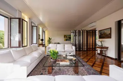 a living room with a white couch and a table at Orange Tree Home in Rome