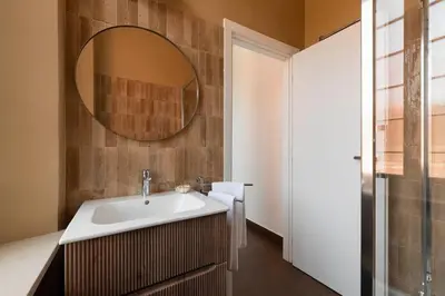 a bathroom with a sink and a mirror at Orange Tree Home in Rome