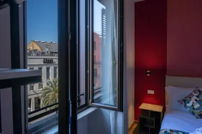 a bedroom with a window with a view of a city at New Roman Experience in Rome
