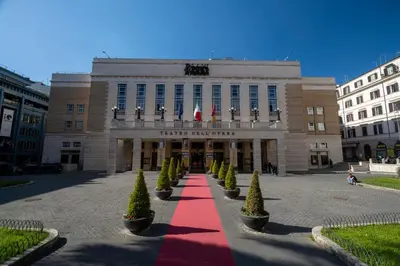 a building with a red carpet in front of it at New Roman Experience in Rome