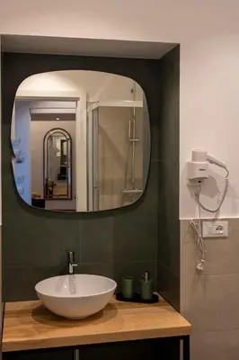 a bathroom with a sink and a mirror at New Roman Experience in Rome